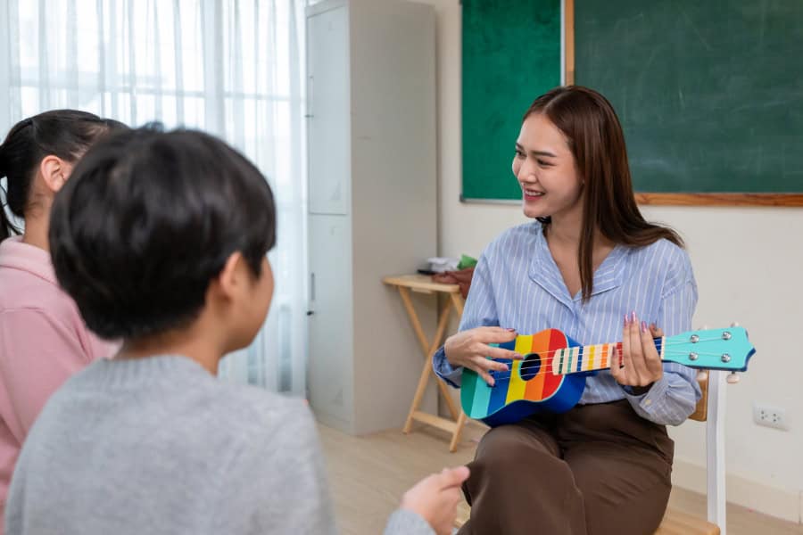 Asian Teacher Singing Together with Children for Speech Therapy